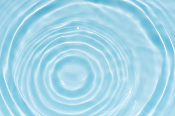 istock Blue water with ripples on the surface. Defocus blurred transparent blue colored clear calm water surface texture with splashes and bubbles. Water waves with shining pattern texture background. 2249495005