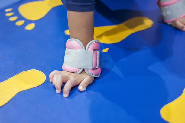 Child Hand Wearing Pink Wrist Support on Playmat