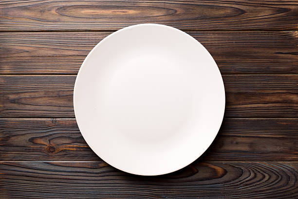 istock Top view of empty light plate on wooden background. Empty space for your design 2249495389