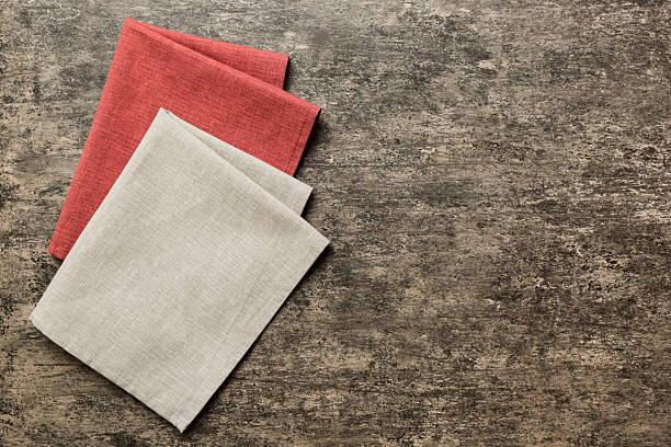 istock top view with gray kitchen napkin isolated on table background. Folded cloth for mockup with copy space, Flat lay. Minimal style 2249495650
