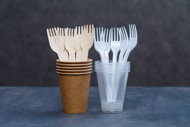 istock Eco-friendly disposable tableware made of bamboo wood and paper on a gray background. Plastic dishes and cutlery. Caring for the environment. Recycling problem. safe planet, environmental concept. 2249497268