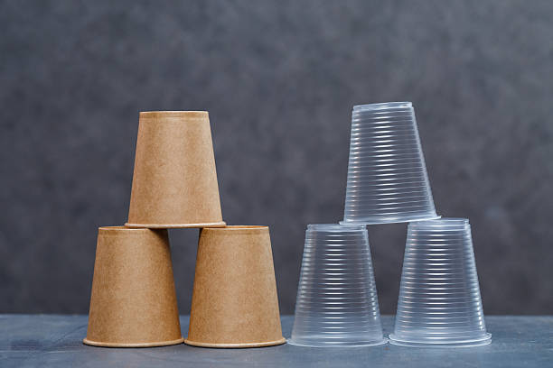 istock Eco-friendly disposable tableware made of bamboo wood and paper on a gray background. Plastic dishes and cutlery. Caring for the environment. Recycling problem. safe planet, environmental concept. 2249497404