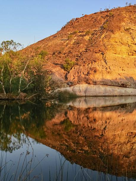 istock A Rocky Gorge next to a Waterhole Turns Red at Sunrise 2249502575