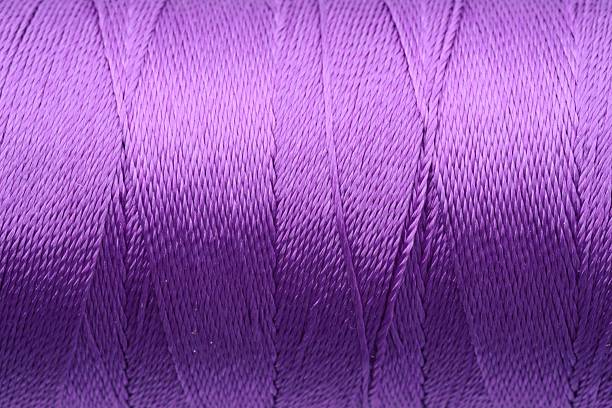 istock Beautiful purple sewing thread as background, closeup 2249502806