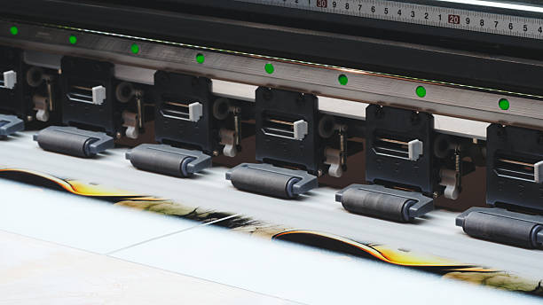 istock Industrial wide-format printing machine prints advertising posters banners on paper, advertising concept background 2249503229