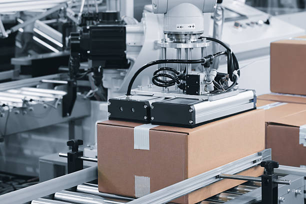 istock Robotic warehouse line packing orders into cardboard boxes, packaging and logistics concept background 2249503707