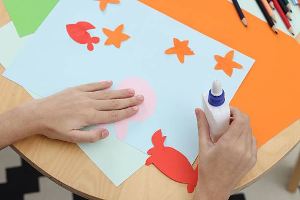 istock Girl making art project at table indoors, above view 2249503840