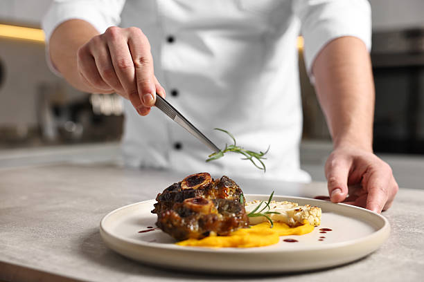 istock Professional chef serving dish at table indoors, closeup 2249506074