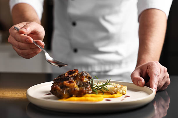 istock Professional chef adding sauce to delicious dish at table indoors, closeup 2249506080