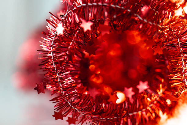 Tinsel with stars .holiday decorating accessory. Red Glitter Star Decorations with Bokeh.