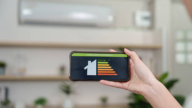 istock Home Energy Efficiency. A person checking energy efficiency on smartphone app. 2249509161