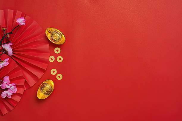 istock Chinese New Year decorations with gold ingots and flowers 2249509786