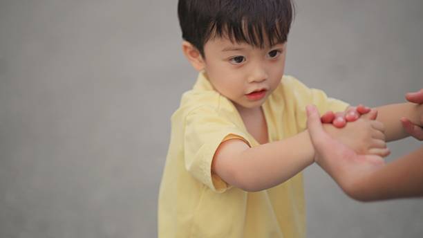 istock Asian Four-Year-Old Learning Skateboarding with Older Sister After School 2249511484