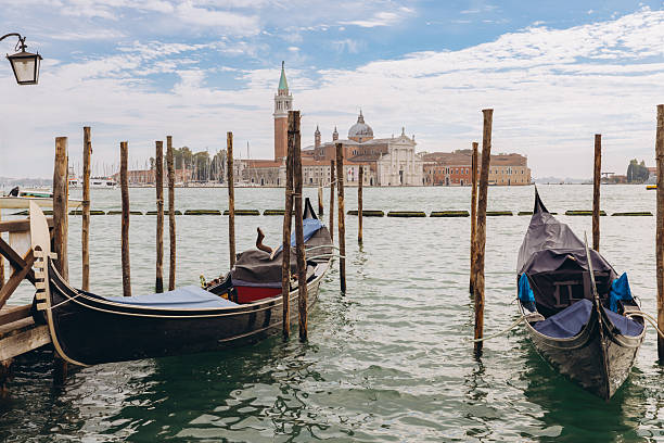 istock Gondolas moored on Venice canal with San Giorgio Maggiore 2249512251