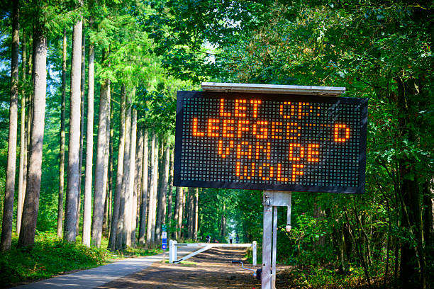 Wolf warning sign at the Renderklippen in Epe at the Veluwe nature reserve in Gelderland, The Netherlands. A wolf has attacked a sheep dog and there have been multiple encounters in the forest around the town of Epe.