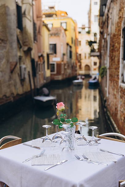 istock Romantic dining table with rose in Venice canal 2249512769