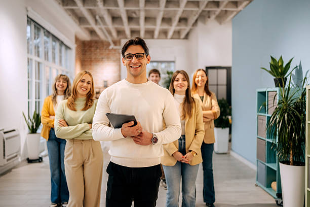 istock Young businessman posing in front of team 2249513948
