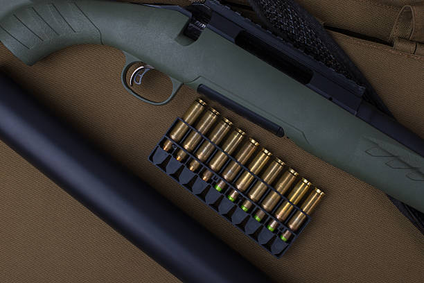 istock Hunting rifle and ammunition on khaki background. 2249515675