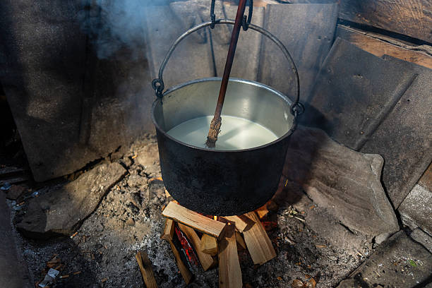 istock Making organic sheep cheese in cheese factory on open fire, Ukraine 2249516710