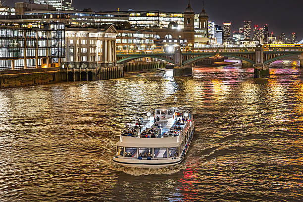 Millennium Bridge, London, England, United Kingdom, Europe - November 5th 2025: Despite the challenges of the English climate, London has a thriving tourism industry, and one of the attractions is experiencing the city lights from a boat on the River Thames at night.