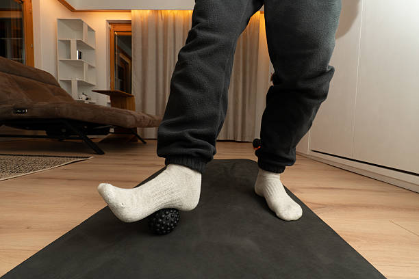 istock Person using massage ball for foot massage and pain relief 2249520522