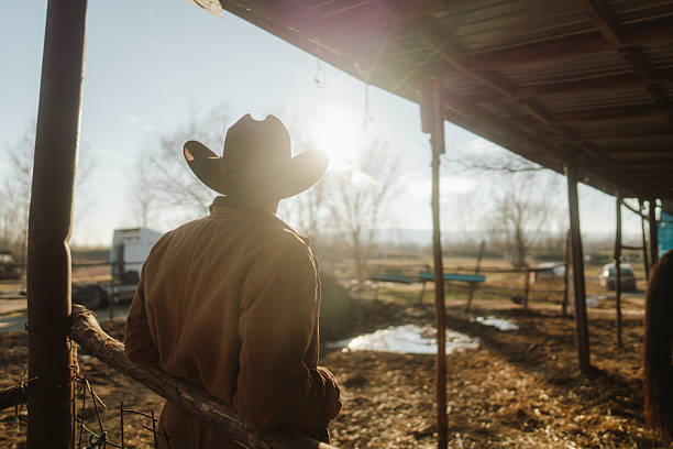 Photo of a mid adult men with a cowboy hat at the horse ranch