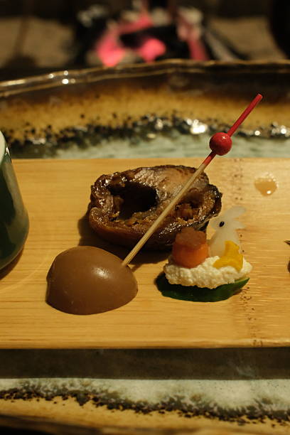 Intricately Plated Japanese Appetizer Set with Fish Head and Artistic Vegetable Carving