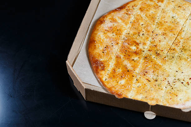 istock Fresh pizza with cheese in a cardboard craft box, freshly baked pizza 2249528424