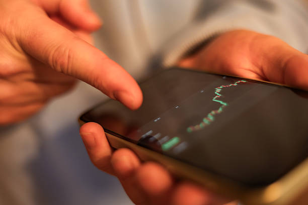 istock High-quality photo of hands holding a mobile phone with cryptocurrency-related text or numbers on the screen. Perfect for tech photography, fintech concepts, crypto market articles, financial apps, and digital currency themes. 2249534372