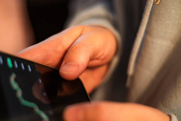 High-quality photo of hands holding a mobile phone with cryptocurrency-related text or numbers on the screen. Perfect for tech photography, fintech concepts, crypto market articles, financial apps, and digital currency themes.
