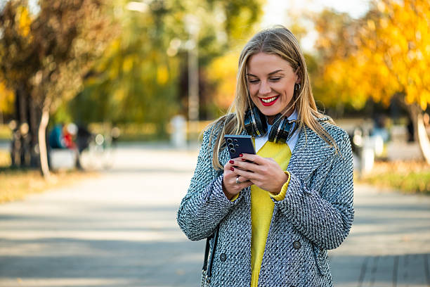 istock Professional woman using mobile app outdoors 2249534530