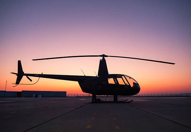 istock A black helicopter is sitting on the ground at sunset. 2249537736