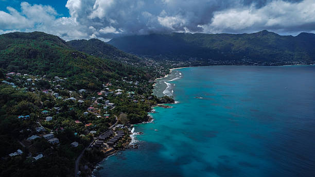 istock Exotic Coastal Scenery with Deep Blue Ocean, Scattered Clouds, and Forested Mountain Range 2249538565