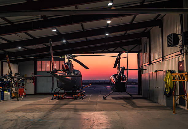 istock Helicopters parked in a hangar at sunset. 2249538776