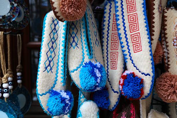 Albanian handicraft products in a souvenir shop in Gjirokaster, Albania. Wool slippers with traditional Albanian patterns.
