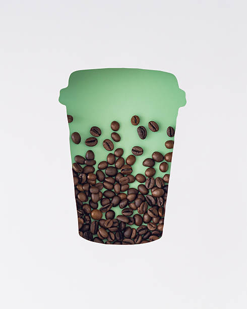 Coffee beans visible through a paper coffee cup shaped gap on pastel green background. Minimal coffee to go concept. Creative trendy takeaway coffee idea. Flat lay style. Top view.
