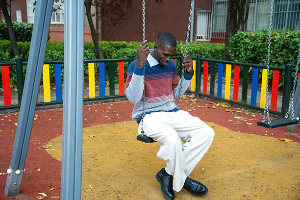 istock Enjoying a peaceful moment on a swing in a vibrant playground during autumn 2249541325