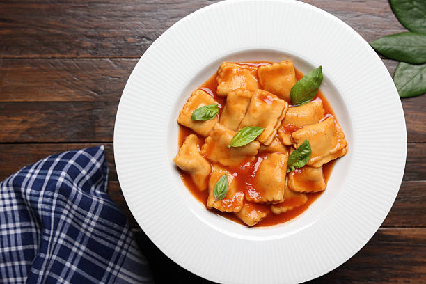 Ravioli are a type of stuffed pasta comprising a filling enveloped in thin pasta dough. Usually served in broth or with a sauce