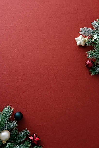 istock Christmas red background with fir branches and decorative baubles. Top view, vertical 2249542599