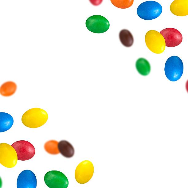 istock Colorful chocolate dragee levitation around the frame - real photo with central copy space on transparent background. 2249543108
