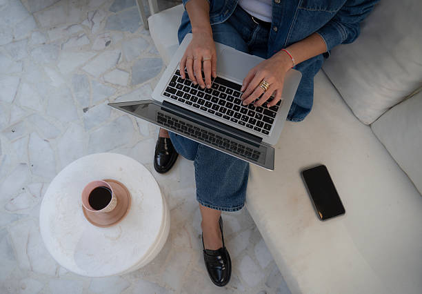 Unrecognizable woman using her laptop at a Sidewalk cafe