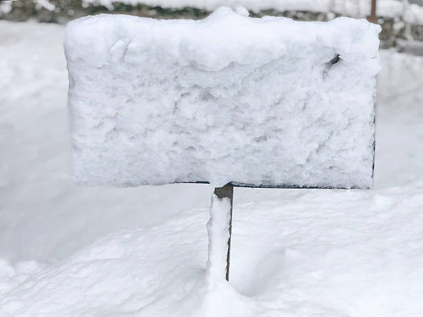 Snow covered signboard in deep winter snow outdoors