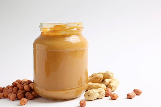 peanut butter and raw peanuts on a colored background. High quality photo