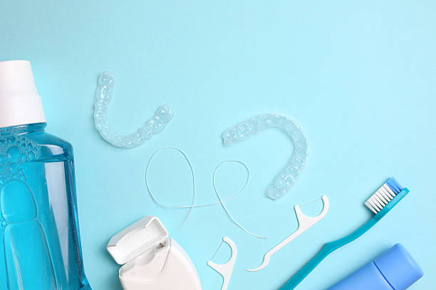 istock Transparent plastic aligners and dentist's tools on a colored background 2249546954
