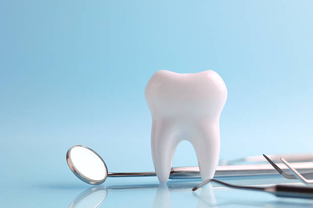 istock Dentistry concept. Model of a tooth and dental instruments on a colored background with space for text. 2249548124