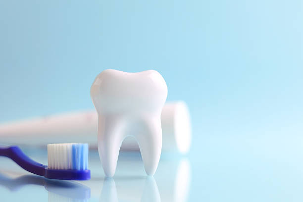 istock Dentistry concept. Model of a tooth and dental instruments on a colored background with space for text. 2249548187