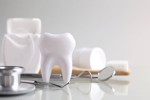 istock Dentistry concept. Model of a tooth and dental instruments on a colored background with space for text. 2249548308