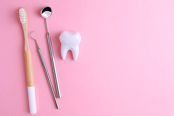 istock Dentistry concept. Model of a tooth and dental instruments on a colored background with space for text. 2249548321