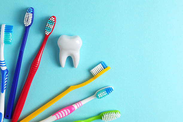 istock Different toothbrushes on a colored background. Dental care, oral health. 2249548657
