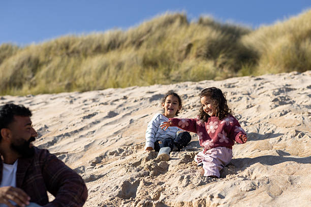 istock Father Watching His Daughters Laugh and Play 2249549167